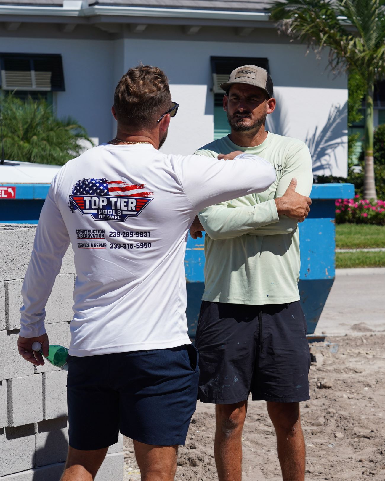 Brant and Blaine of Top Tier Pools talking on a Naples job site