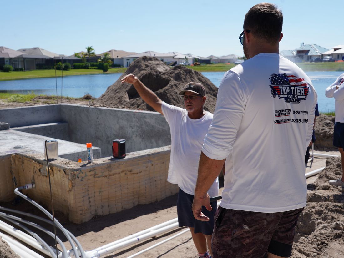 Ben laying out pool details on site with the Top Tier crew