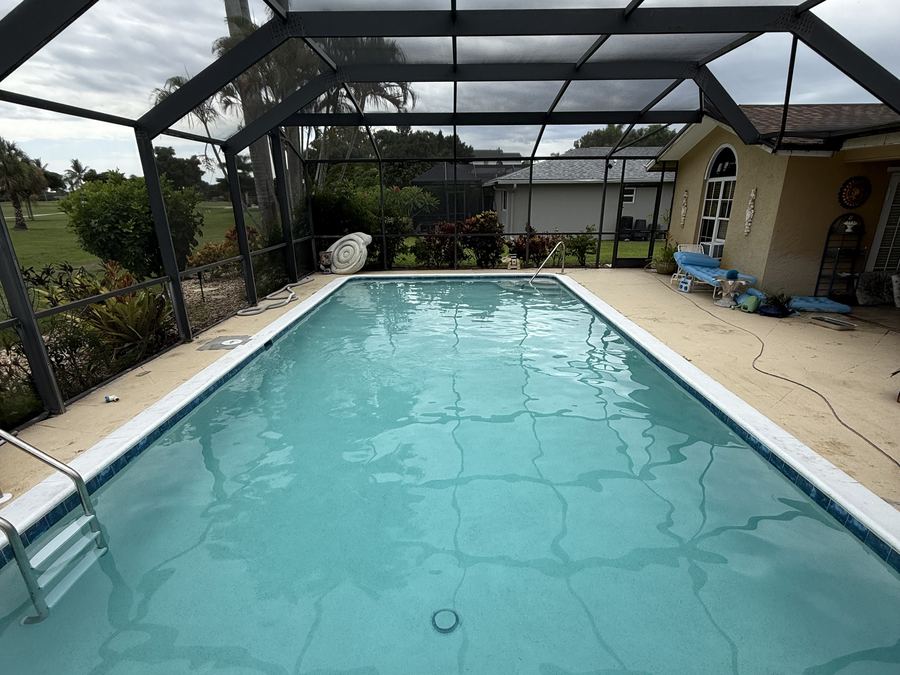Resurfaced screened lanai pool filled with clear water
