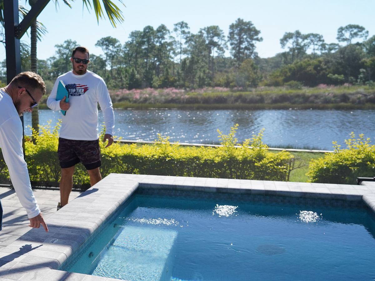 Top Tier Pools inspecting tile on a finished spa in Naples