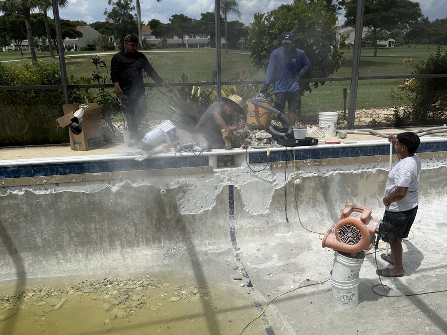 Old pool surface being chipped out during renovation
